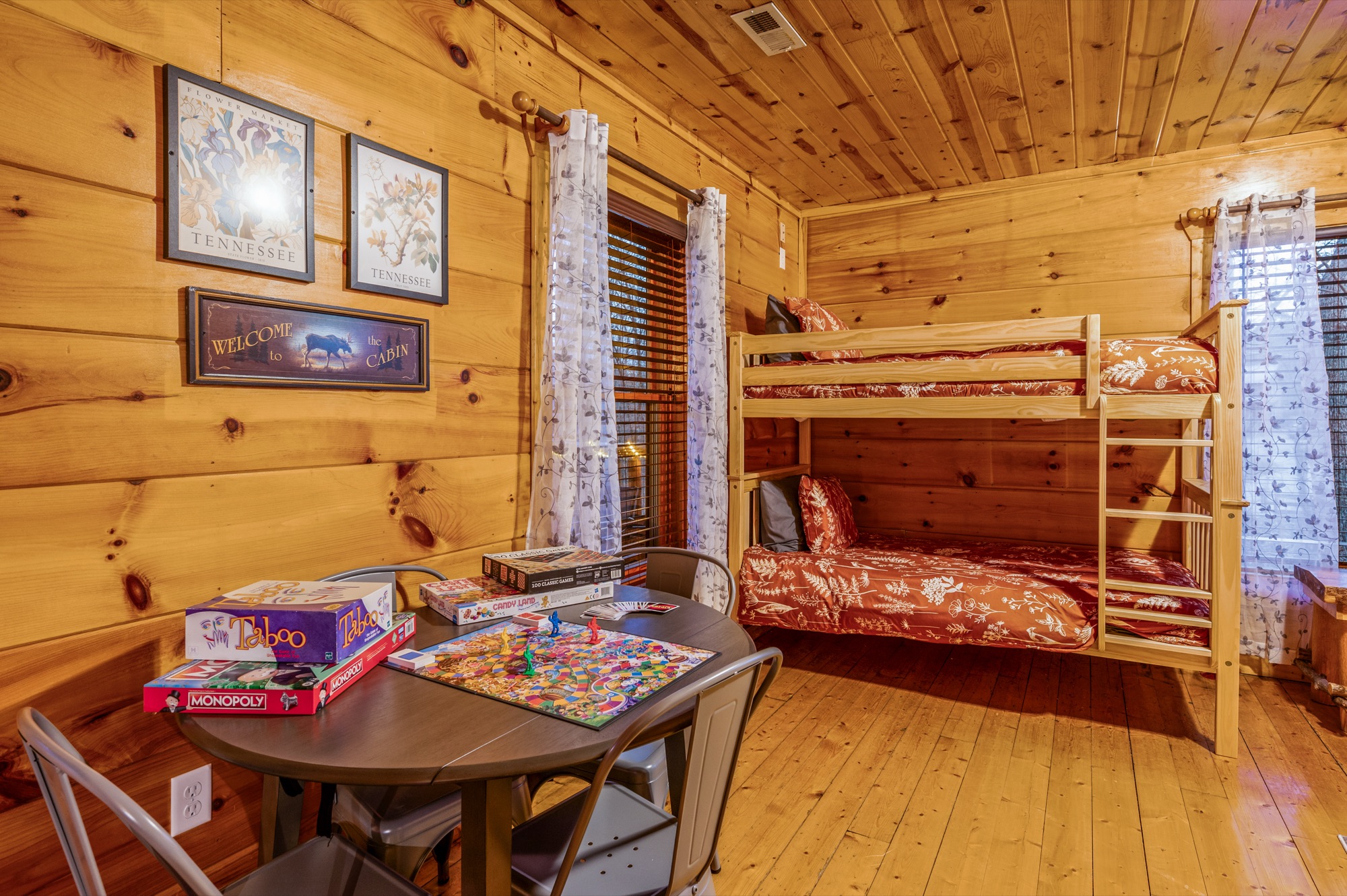 Bunk room at Bearadise with Tennessee themed prints and a table set up for board games